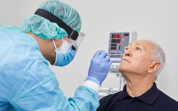 man getting nasal swab for COVID-19 test